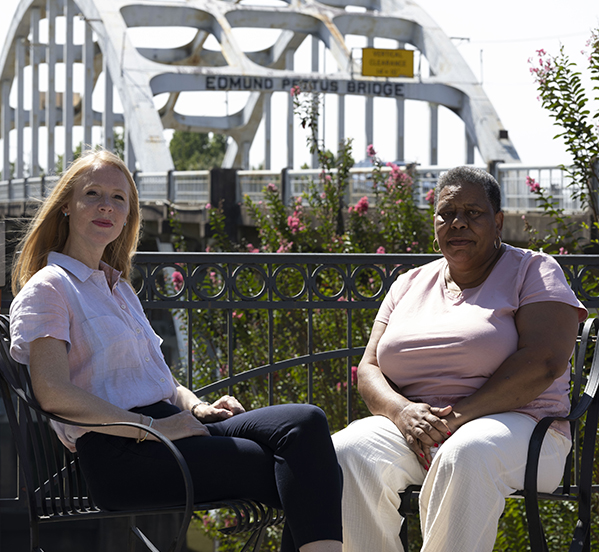 JoAnne Bland of Journeys for the Soul with Darley Newman with the Edmund Pettus Bridge in the background in Selma.